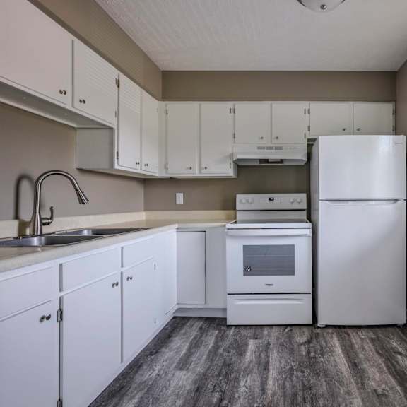 a kitchen with white appliances and cabinets.