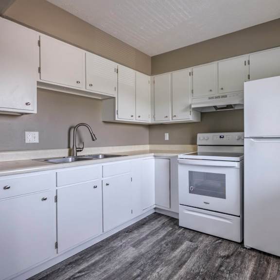 a kitchen with white appliances and cabinets.