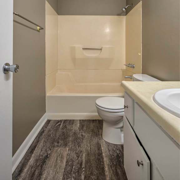 a bathroom with a toilet, sink, and bathtub.