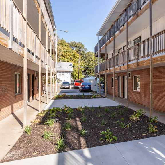 a long, narrow courtyard between two rows of apartment buildings.