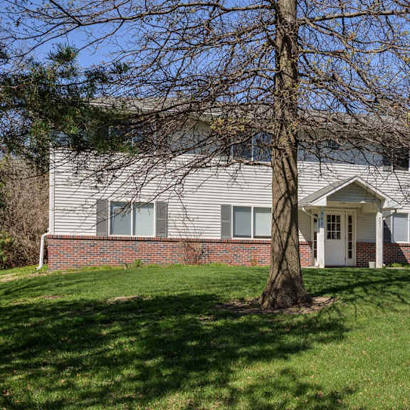 a house with a tree in front of it.