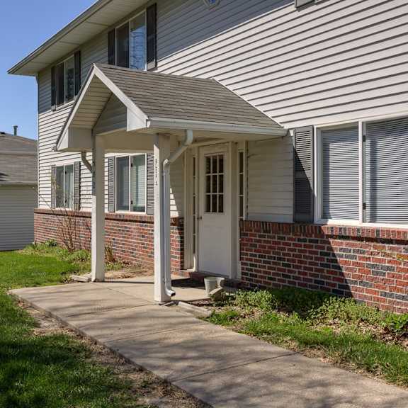 a house with a white door and a small porch.