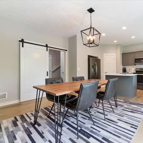 a modern kitchen with a dining table and chairs.