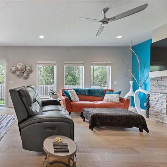 a modern living room with a dining table and chairs.