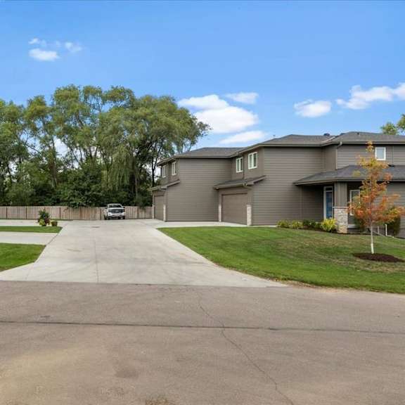 a row of houses with a driveway in the middle.