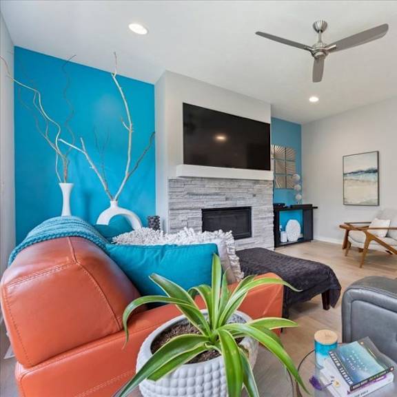 a living room with a fireplace and a television.
