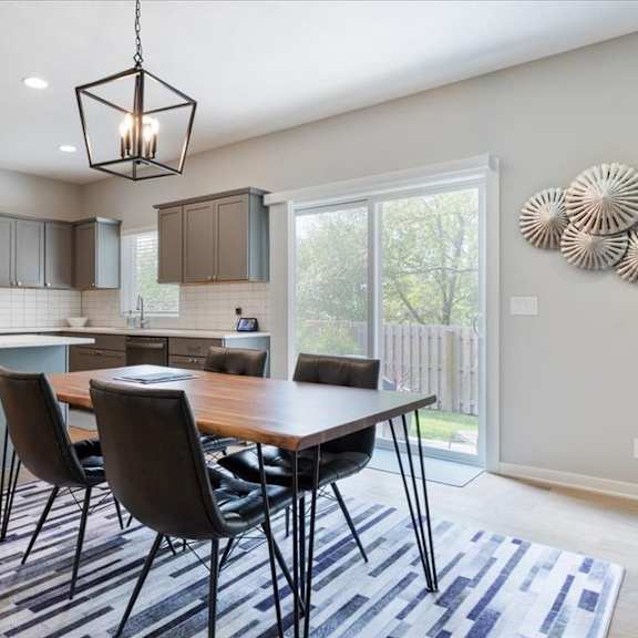 a modern kitchen with a dining table and chairs.