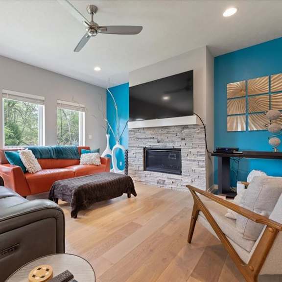 a living room with a fireplace and a television.