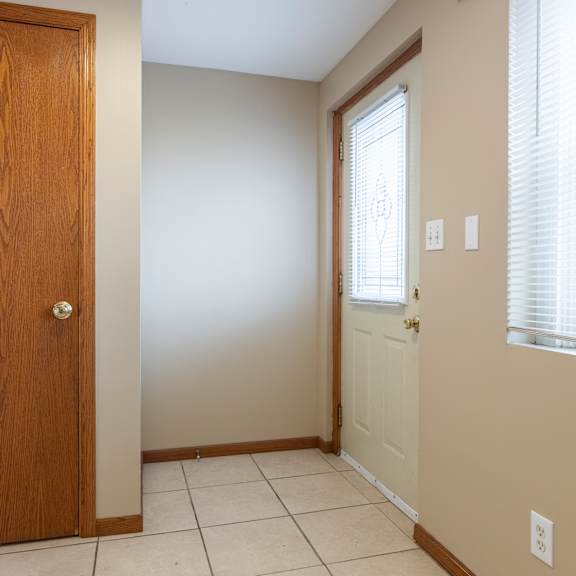 a room with a brown door and a white door.