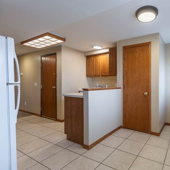 a kitchen with a white refrigerator and a white counter.