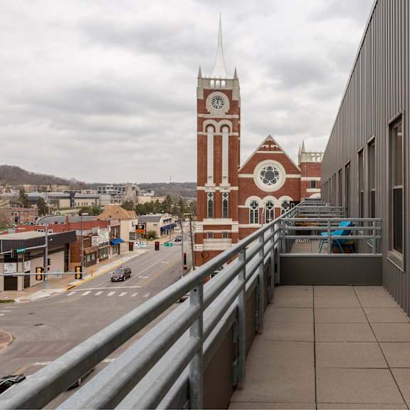 a view of a city street with a clock tower in the background.