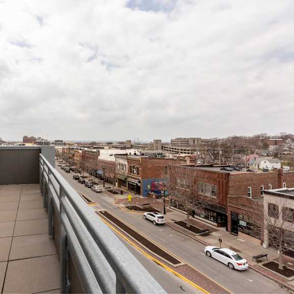 a view from a balcony overlooking a city street.