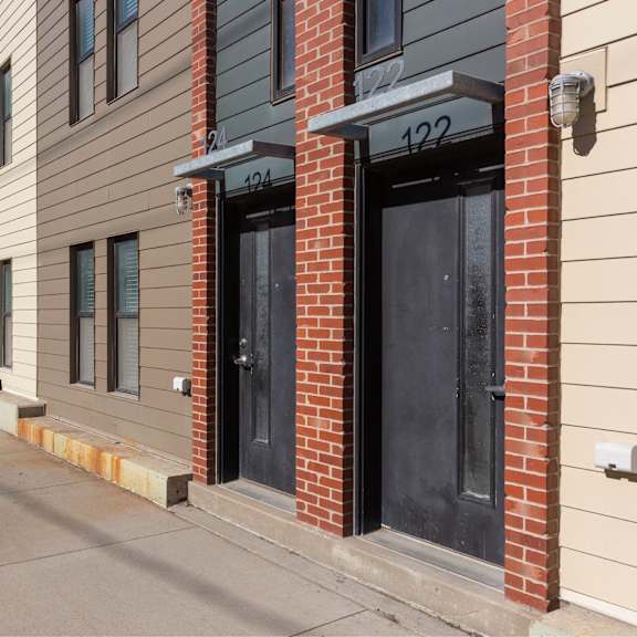 a row of townhouses with numbers 404 and 122 on the front.