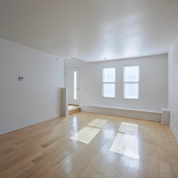 a room with wooden floors and white walls.