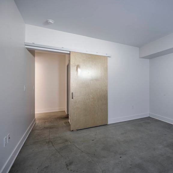 a room with a door and a wall socket.