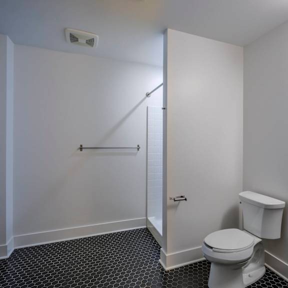 a white toilet sits next to a sink in a small bathroom.