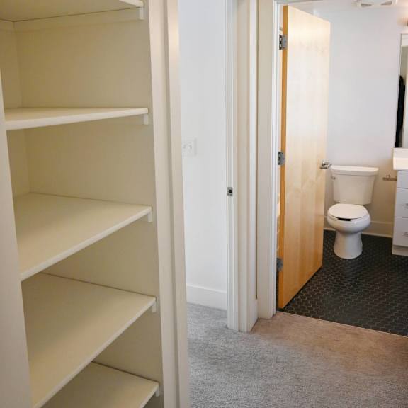 a white door is open to a bathroom.