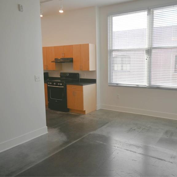 a kitchen with black appliances and wooden cabinets.