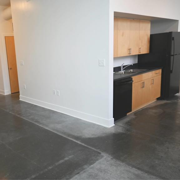 a kitchen with black appliances and wooden cabinets.