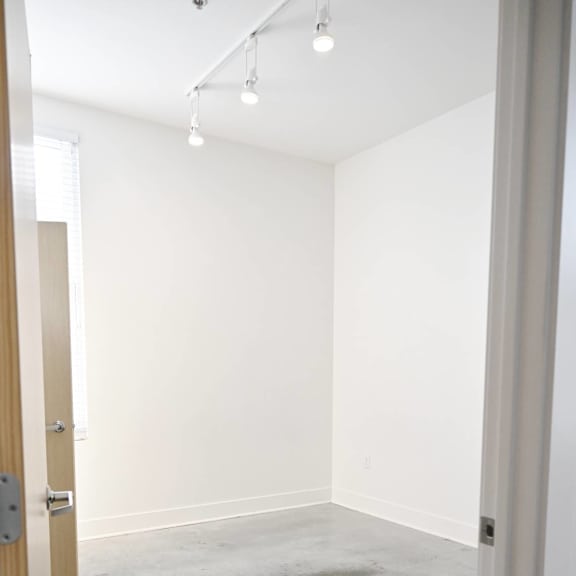 a room with a concrete floor and white walls.