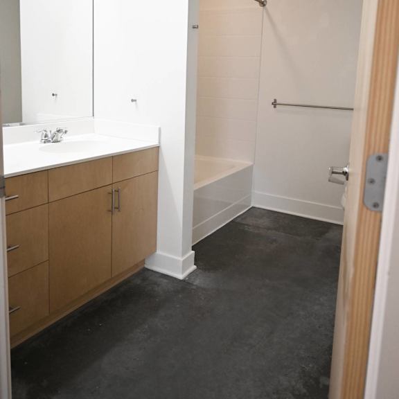 a bathroom with a walk in shower and a vanity.