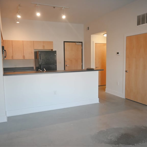 a room with a white counter and a wooden door.