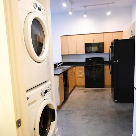 a white washing machine is in a doorway.