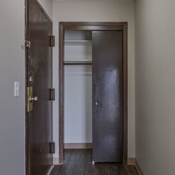 a brown door with a glass window is open.