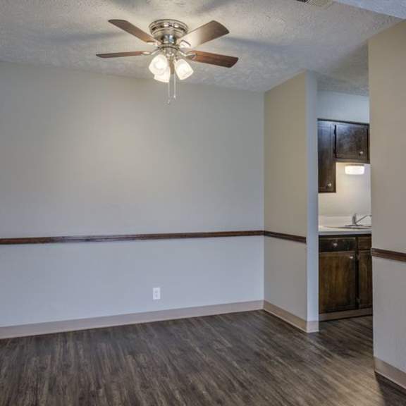 a room with a ceiling fan and a light fixture.