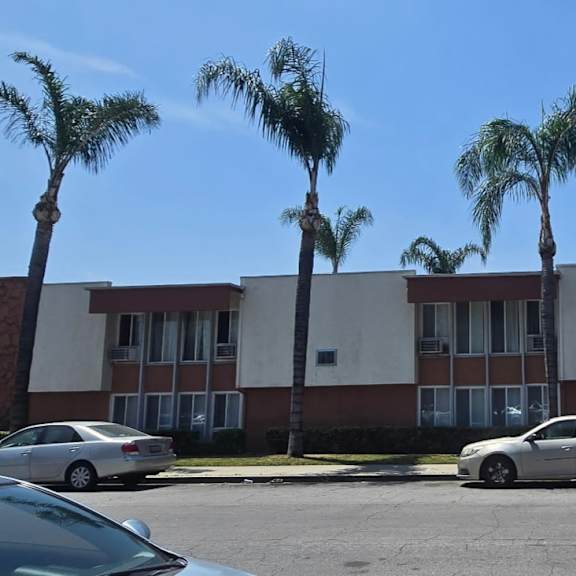 a building surrounded by palm trees