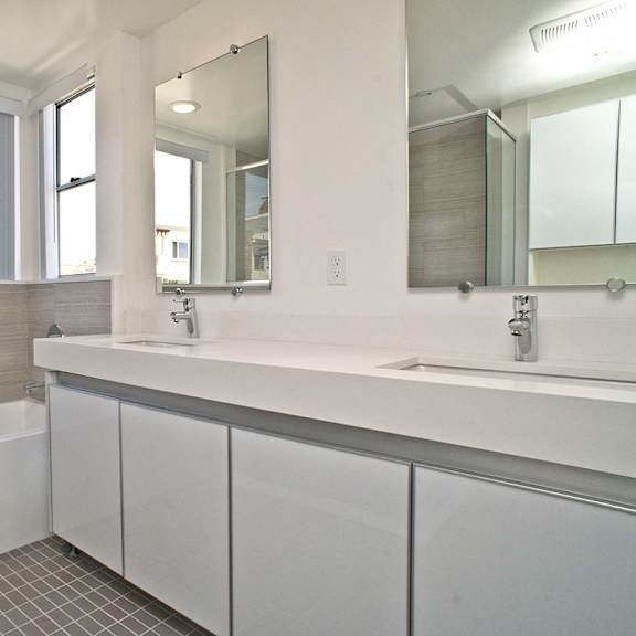 master bath with full-size bathtub and double sinks