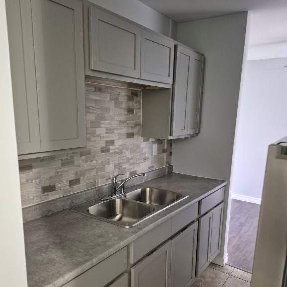 a kitchen with a sink and a counter.