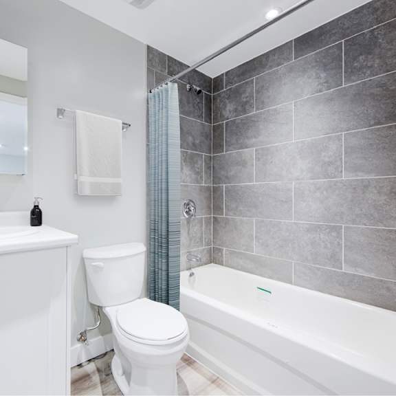 renovated bathroom with vinyl plank flooring.