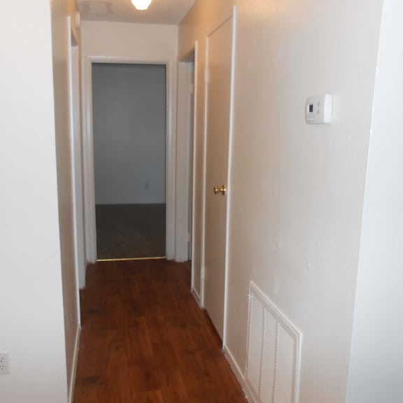 a hallway with a door at the end.