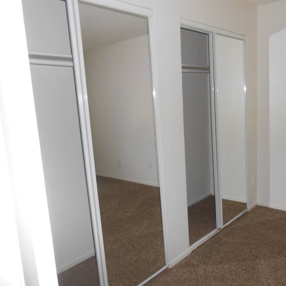 a room with white walls and brown carpet.