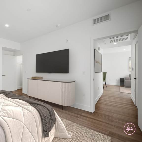 a bedroom with a large bed and a television in the corner.