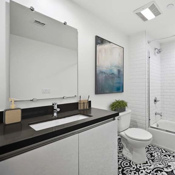 a bathroom with a black and white tiled floor.