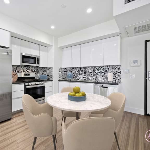 a modern kitchen with a dining table set for four.