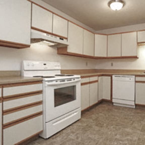 large kitchen with white cabinets and white appliances