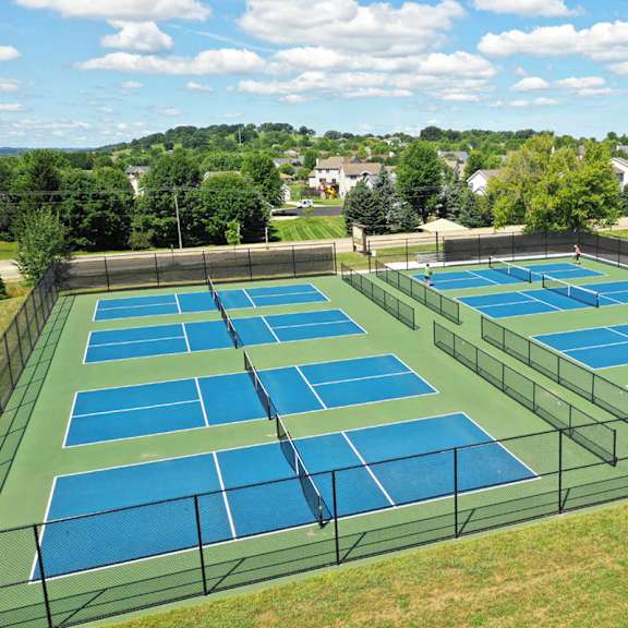 an aerial view of the tennis courts at the club
