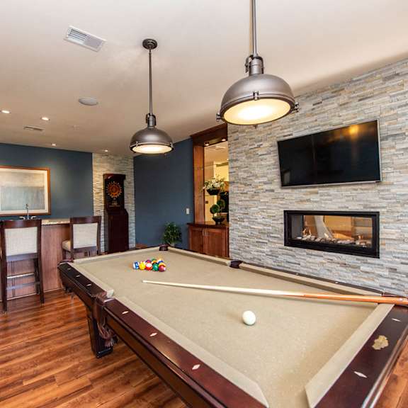 a game room with a pool table and a fireplace