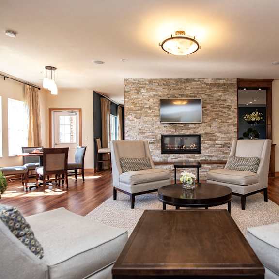 a living room with couches and chairs and a fireplace