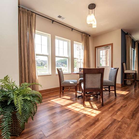 a dining room with a table and chairs on a wood floor