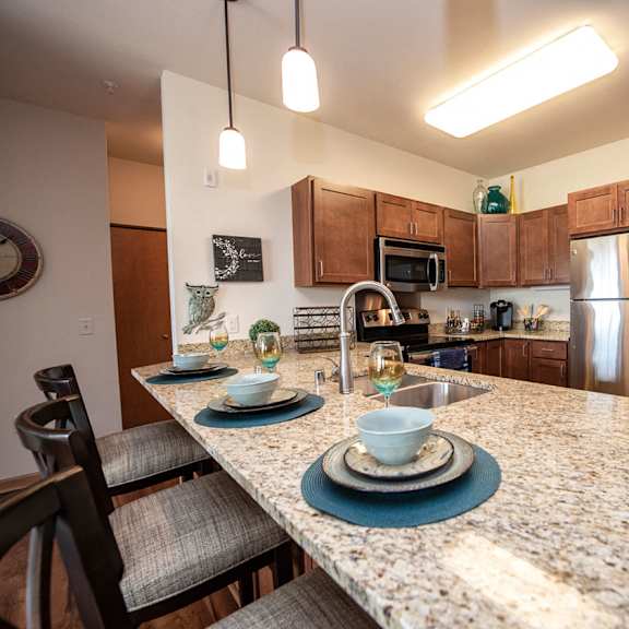 a kitchen with granite counter tops and stainless steel appliances
