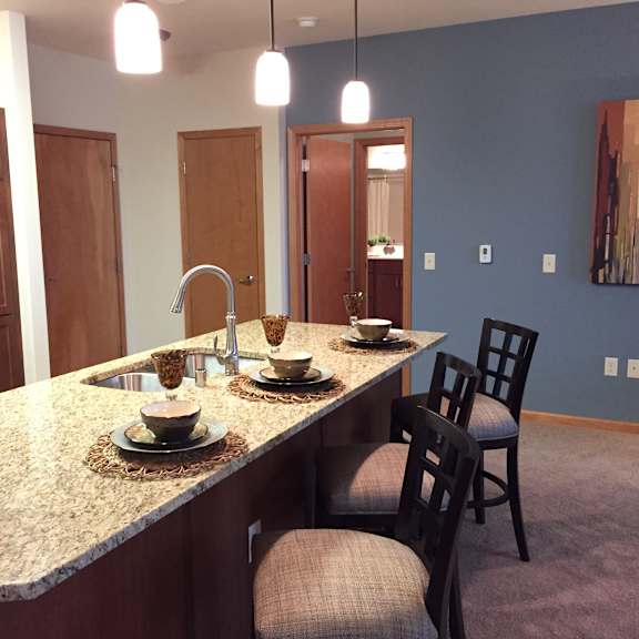 gourmet kitchens with islands, caesarstone countertops, and decorative backsplash at paragon place at bishops bay, 5240 bishops bay parkway, wisconsin