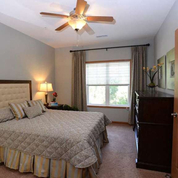 cozy bedrooms with ceiling fans at highlands at riverwalk apartments 55+, mequon, wi,53092