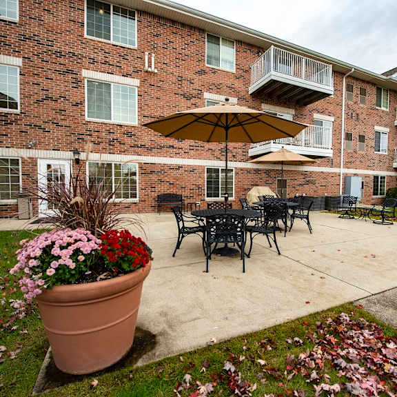 a patio with a table and chairs and an umbrella.
