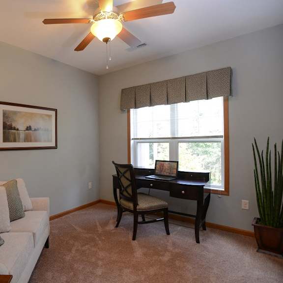 living rooms with wall to wall carpeting at the highlands at mahler park apartments 55+, neenah, wisconsin