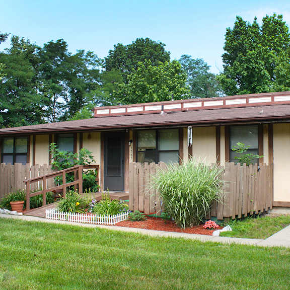 a house with a porch and plants in front of it at wentworth estates apartments, kentucky