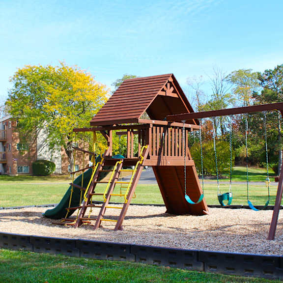 a playground with a swing set in a park  at wentworth estates apartments, kentucky